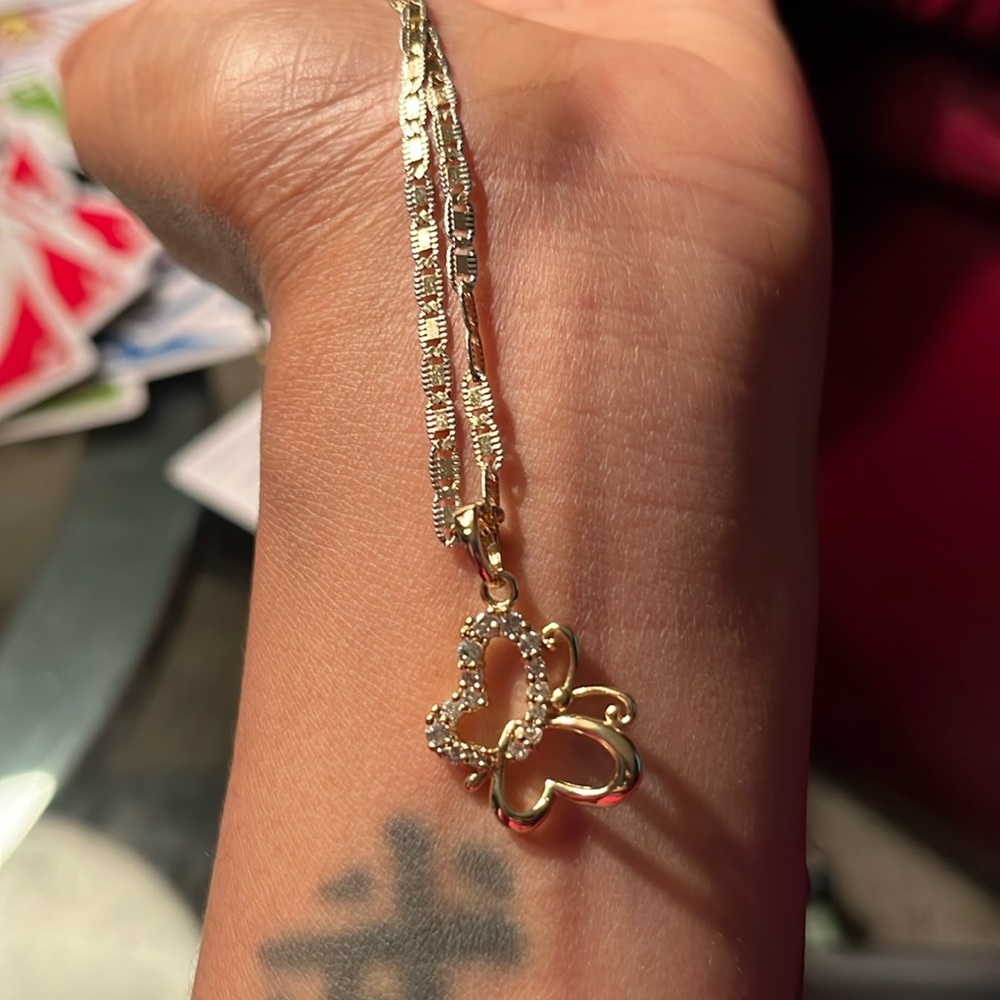 Gold filled necklace and gold filled butterfly charm that has CZ stones in it